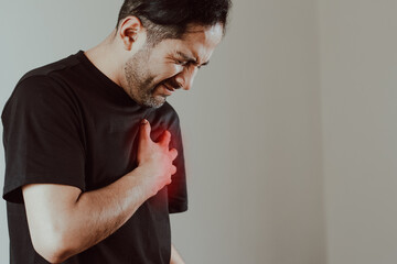 Photo of person clutching chest in pain. Concept of diseases, cardiac arrest, heart pain, health.