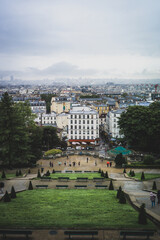 Parisian cityscape, with typical Parisian architecture and landmarks like the sa creu coeur and the Eiffel Tower can be seen. The picture was taken near the square pigalle.