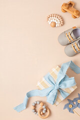 Baby shower, gender reveal, birthday party background with gift box and baby toys. Top view,...
