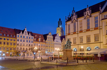 Market square in Wroclaw with colorful buildings, new town hall and statue of Alexander Fredro