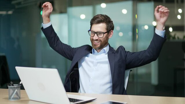 Resting entrepreneur investor with hands behind head feels satisfied with work well done indoor Calm bearded businessman relax after hard working day finished project job on computer at modern office