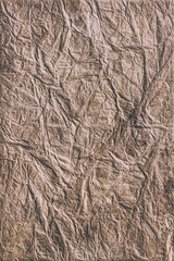 Textured brown wrinkled handmade paper background. Vertical background for design