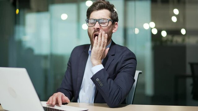 Bored business man in office Sleeping sleepy yawning boredom at workplace indoors Tired Exhausted Businessman entrepreneur in formal suit Portrait Depressed, unhappy, workless male manager workplace