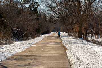 People walking on the Fox River Trail near De Pere, Wisconsin, in winter snow
