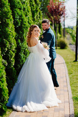 Fototapeta na wymiar the groom leads the bride by the hand along the path. 