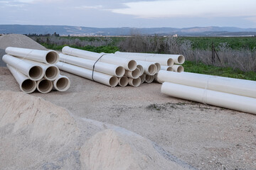 Plumbing. new PVC pipe heap, pile near the construction site for the preparation of the sewer...