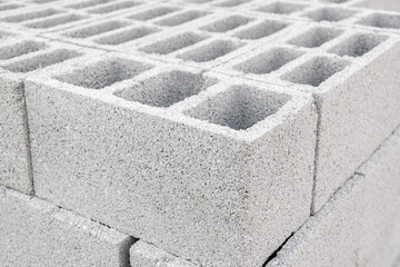 Pallet of Concrete Cinder Blocks, Grey Uniformed brick Shapes building material. New for use  on construction site in Israel.