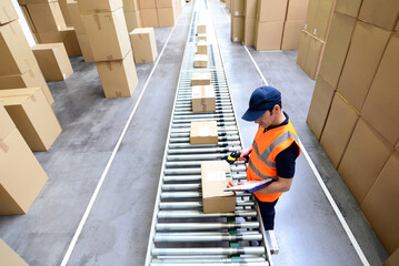workers in the warehouse scanning parcels for retail and transport shipping