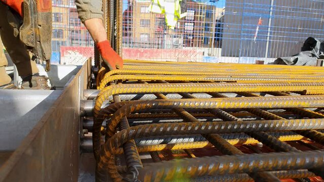 Steel fixer adjusting rebar to slab edge.