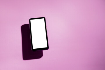 Smartphone with white screen on top of a pink table. Cell phone concept. White screen concept. png