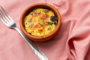 Vegetable casserole with cheese on pink background, Coral-Colored Background with Delicious Vegetable Casserole