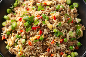 Asian Beef Fried Rice with eggs and vegetables in black bowl