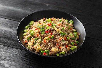 Asian Beef Fried Rice with eggs and vegetables in black bowl