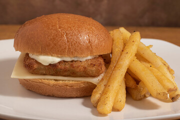 fish sandwich top with tarter sauce  and swiss cheese