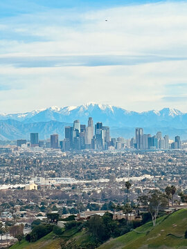 View at Downtown Los Angeles with the snowcapped San Gabriel Mountains in the background. 