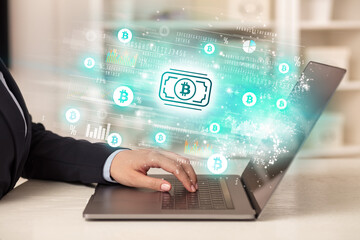 Young man watching stock market on laptop