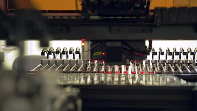 Installation of electronic components on a printed circuit board. Production of microelectronics and semiconductors by a modern robot. High-tech equipment for assembling chips at the factory.