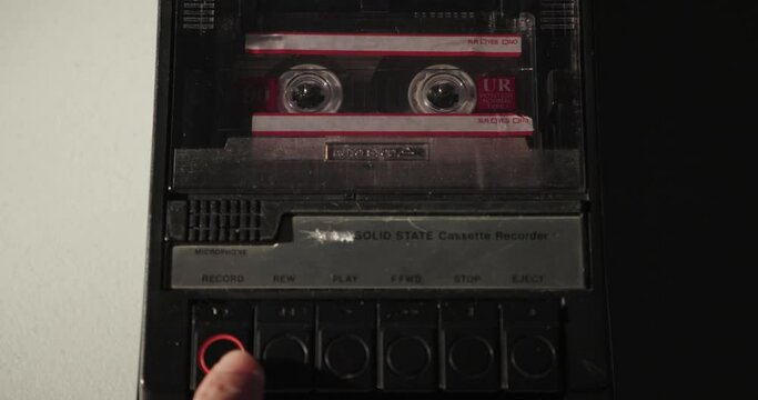 Close-Up Of Tape Being Loaded Into Cassette Recorder And Record Button Pressed