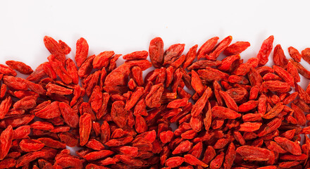 Red dried goji berries on white surface. Natural food background..