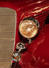 Headlight and radiator grill of old classic car