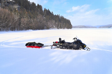 Snowmobile pulling a sled