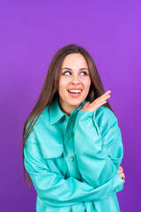 Fototapeta premium Close up portrait of young woman, cheerful isolated on purple studio background in blue windbreaker, vertical photo