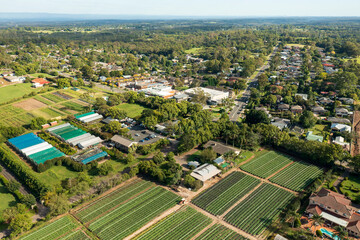 Aerial view of houses, shops and farms in the outer Sydney township of Galston, NSW, Australia.