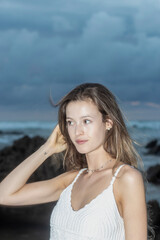 Naklejka premium Beautiful young blond woman outdoors portrait near the sea