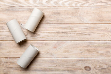 Flat lay composition with empty toilet paper rolls and space for text on color background. Recyclable paper tube with metal plug end made of kraft paper or cardboard
