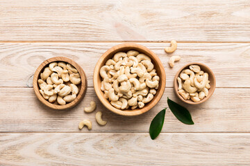 cashew nuts in wooden bowl on table background. top view. Space for text Healthy food