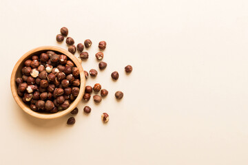 Wooden bowl full of hazelnuts on table background. Healthy eating concept. Super foods
