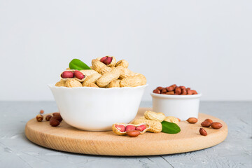 Fresh healthy peanuts in bowl on colored table background. Top view Healthy eating bertholletia concept. Super foods