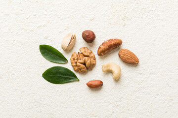 Composition of nuts , flat lay - mix hazelnuts, cashews, almonds on table background. healthy...