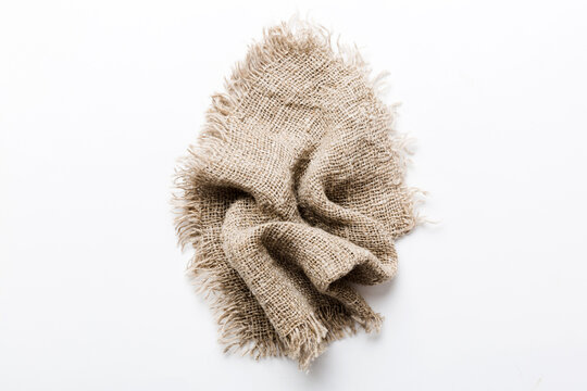 Old burlap fabric napkin, sackcloth on table background. top view with copy space