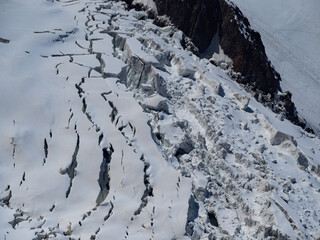 Snow covered mountains. Mont Blanc glacier moving and melting down the slope of the mountain. Chamonix. France