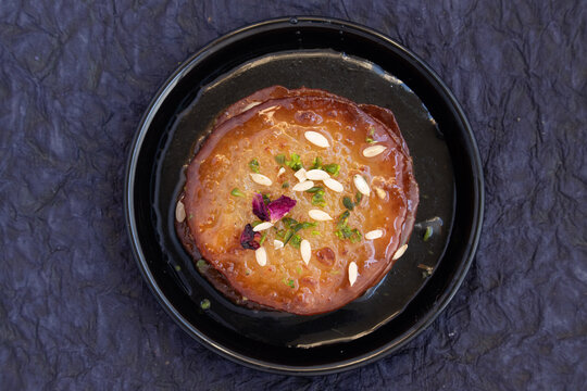 Juicy Sugary Pancakes Sweets Also Called Malpua, Pooa Or Pua Are Traditional Indian Dessert Mithai Drenched, Dunked, Soaked Or Dip In Sugar Syrup Cheeni Ki Chasni. Enjoyed On Holi, Navratri and Diwali