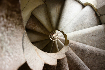 spiral staircase in light stone giving the impression of a vertigo tunnel.
