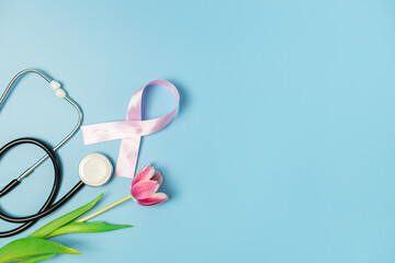 One pink ribbon with a tulip and a stethoscope on a blue background.