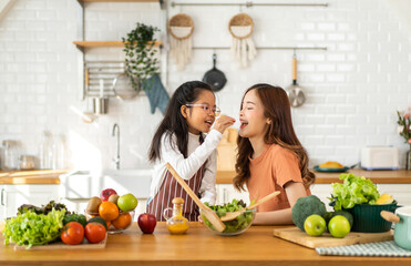Portrait of enjoy happy love asian family mother and little asian girl daughter child having fun...