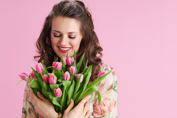 happy woman in floral dress on pink