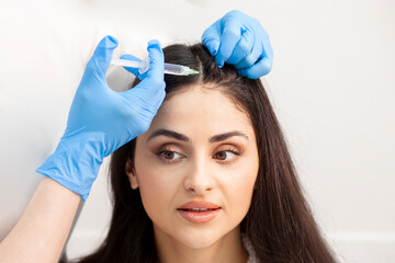 hair mesotherapy procedure in cosmetology clinic, cosmetologist doctor makes injection of botulinum toxin