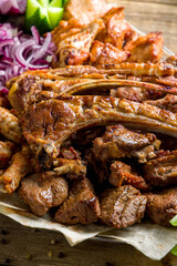 platter of different kebabs on old wooden table, chicken,lamb,beef,pork,turkey,lula kebab macro close up vertical