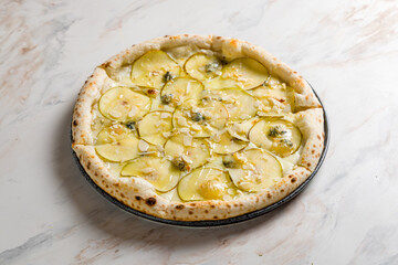 Pizza with pears and Gorgonzola cheese on marble table