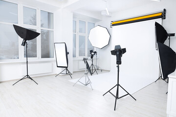 Interior of modern photo studio with professional lighting equipment