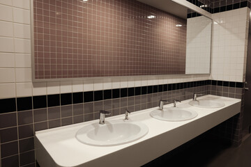 Public toilet interior with sinks and mirror