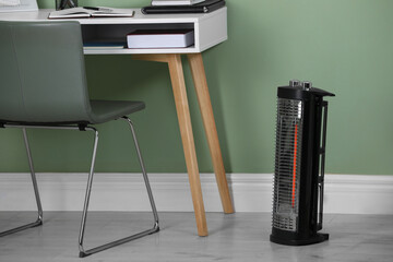 Modern infrared heater on floor in room