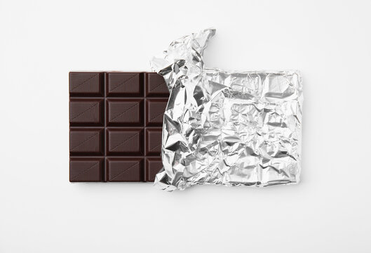 Tasty chocolate bar on white background, top view