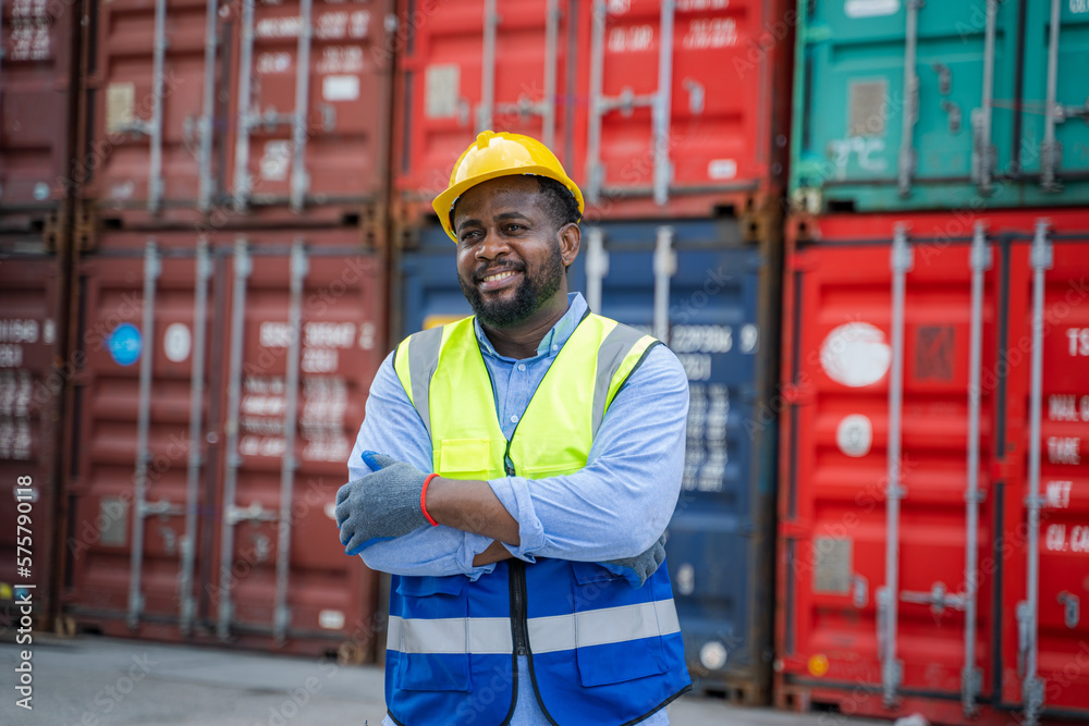 Poster foreman checking about shipping of container box in warehouse stock yard.