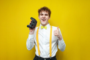 guy in festive outfit holds joystick, nerd gamer in bow-tie shirt and suspenders advertises gamepad