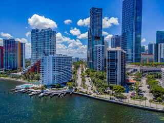 Aerial view of Miami South Channel at Miami Beach, Florida. Modern multi-storey buildings with streets in between and blue sky with clouds at the background.